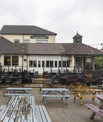 Exterior beer garden of a pub with a seating area.