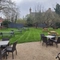 Outdoor Beer Garden with tables and benches on grass and gravel