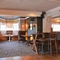 Interior dining area of a pub with a TV.