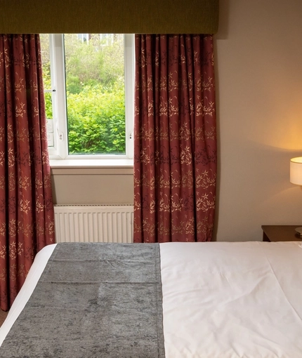 A double bed within the interior of one of the hotel rooms at The Wellington Hotel.