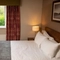 A double bed within the interior of one of the hotel rooms at The Wellington Hotel.