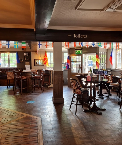 Indoor seating area in a bar, flags as decoration