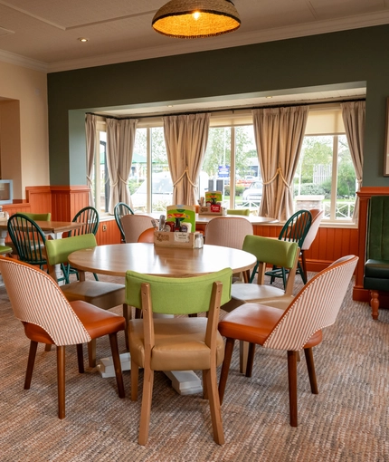 The interior restaurant seating area with tables, chairs and cushioned seating at The Farmhouse Kitchen Willington.