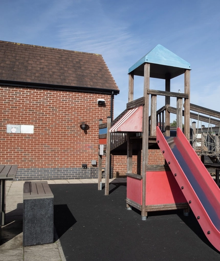 Exterior play area of a pub with a seating area.