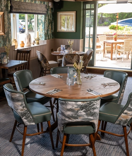 Some tables in the restaurant of the Three Horse Shoes.