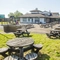Exterior beer garden of a pub with a seating area and a play area.