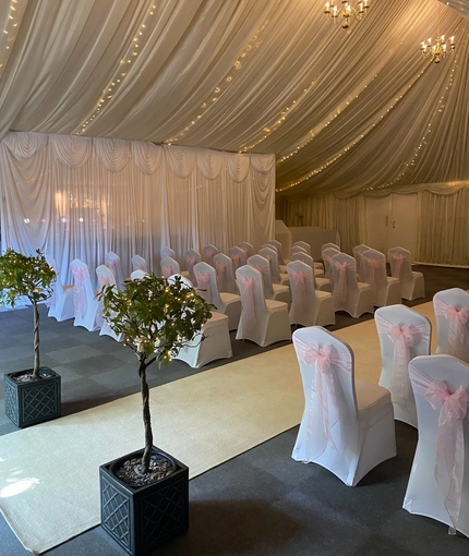 A marquee, decorated for a wedding.