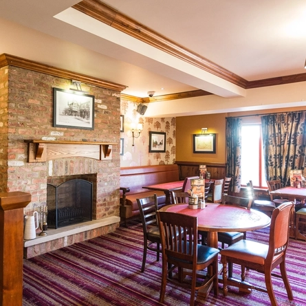 interior dining area of a pub with a fireplace