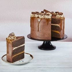 a cake on a stand next to a slice of it on a plate