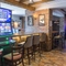 Interior dining area of a pub with gambling machines.