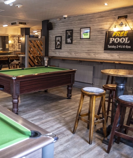 Pool table area with high stools