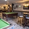 Pool table area with high stools