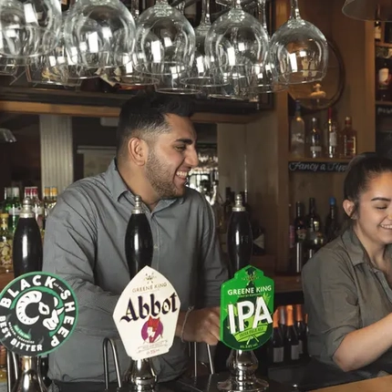 Team members serving behind the bar