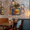 The interior restaurant seating area at The Man On The Moon, with upholstered booth seating and framed artwork on the wall.