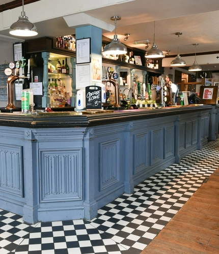 Interior bar area of a pub with a seating area.