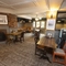 Interior dining area of a pub with a fireplace.