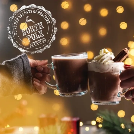 Two hot chocolates being cheersed.