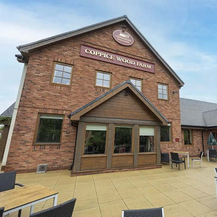 Exterior facade of a pub with a seating area.