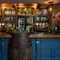 A close up view of the blue, wood panelled bar of The Royal Oak, with a large beer barrel built into the counter.