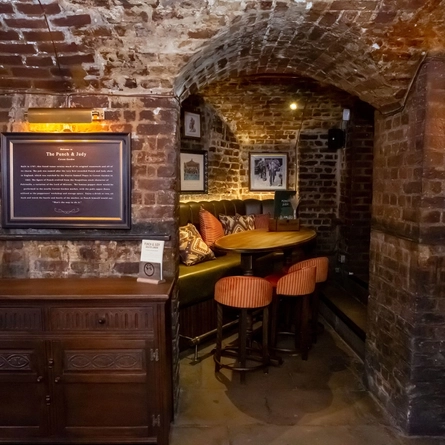 Interior of table with bar stools and sofa