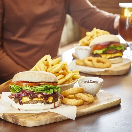 Burger, chips and onion rings at a Pub & Carvery restaurant