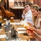 A group of people enjoying drinks and viewing the menu within the interior restaurant seating area during The Durell Arms launch party.