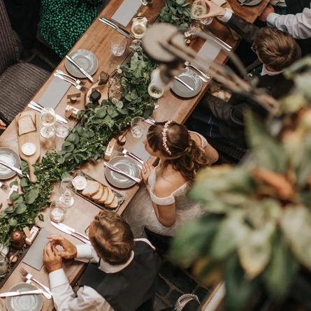 An interior shot of people enjoying food celebrating a Wedding at the Ubiquitous Chip in Glasgow.