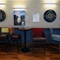 Interior dining area of a pub with a few dartboards.