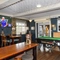 Interior dining area of a pub with a pool table and a TV.