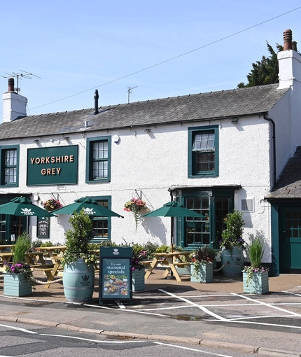 The exterior facade and beer garden seating area at The Yorkshire Grey.