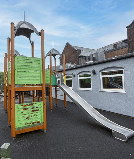 Exterior beer garden and play area of a pub.