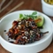 Teryaki chicken skewers, toasted seed and puffed rice, with sunflower seed satay served in a side dish