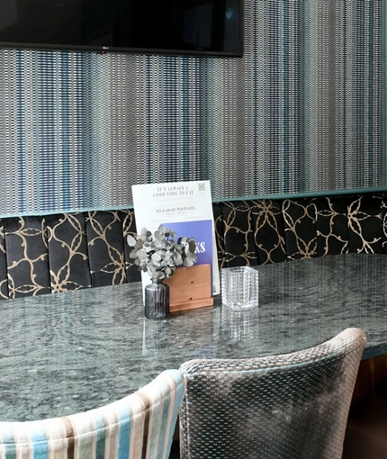 The interior restaurant seating area with TV at The Duke Of Cambridge.