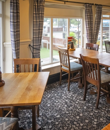 Interior dining area of a pub with a TV.