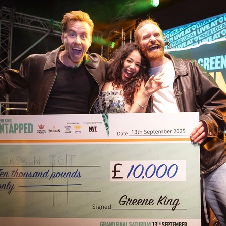 An image of Jasmin Jet being presented with a cheque from Sam Ryder and Danny Jones at The Untapped Live At Your Local Final at The Coach House At The George.