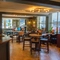 The interior bar and restaurant seating area with TV and fireplace at The Hare & Hounds.