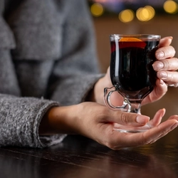 a woman holding a glass of wine in a pub