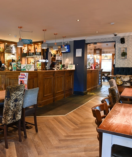 Interior dining area of a pub with a bar.