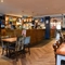 Interior dining area of a pub with a bar.