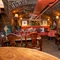 Interior seating area with several tables and chairs surrounding