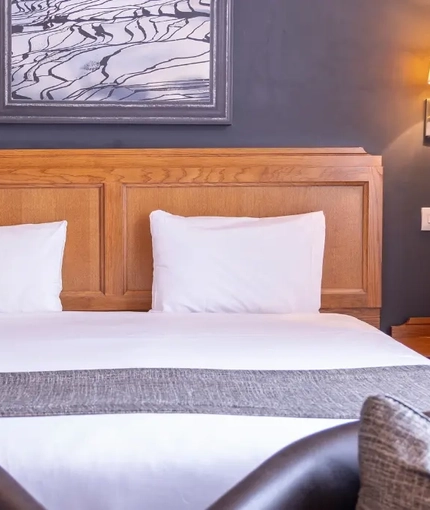 The interior hotel king bed bedroom at the Brentwood.