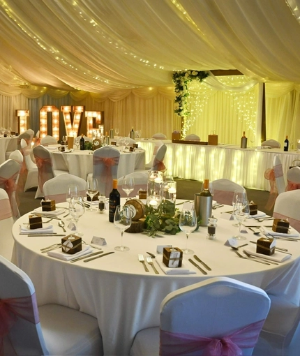 A marquee, decorated for a wedding.