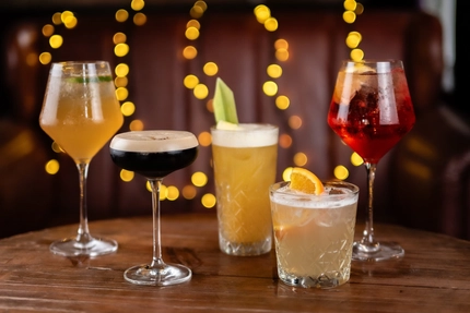a few drinks sitting on a wooden table of a pub
