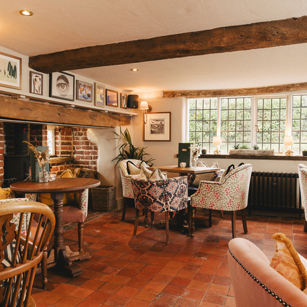 The interior restaurant and seating area with fireplace at The Crown.