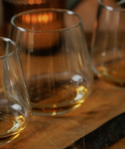 A lifestyle image of a Whiskey Flight board from the Burns Night menu sat on a table within the interior restaurant seating area at The Crown.