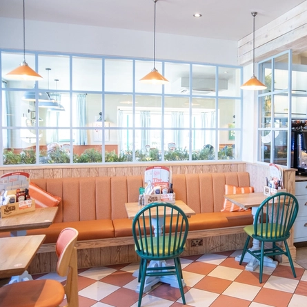 The restaurant seating area and self-serve drinks counter of the Farmhouse Kitchen in Worsley.