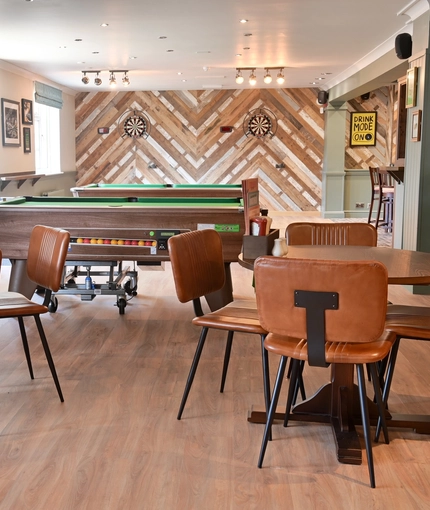 The interior restaurant seating area with TV, pool tables and dartboards at The Greengage.