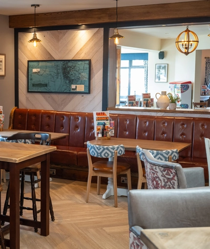 The interior restaurant and seating area with TV at the Gatehouse.