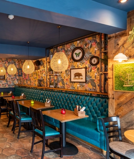 Interior dining area of a pub with a TV.