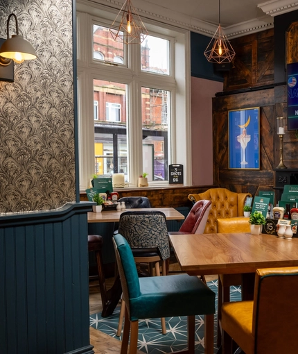 The interior restaurant and seating area with TV and fireplace at the Ship and Royal.